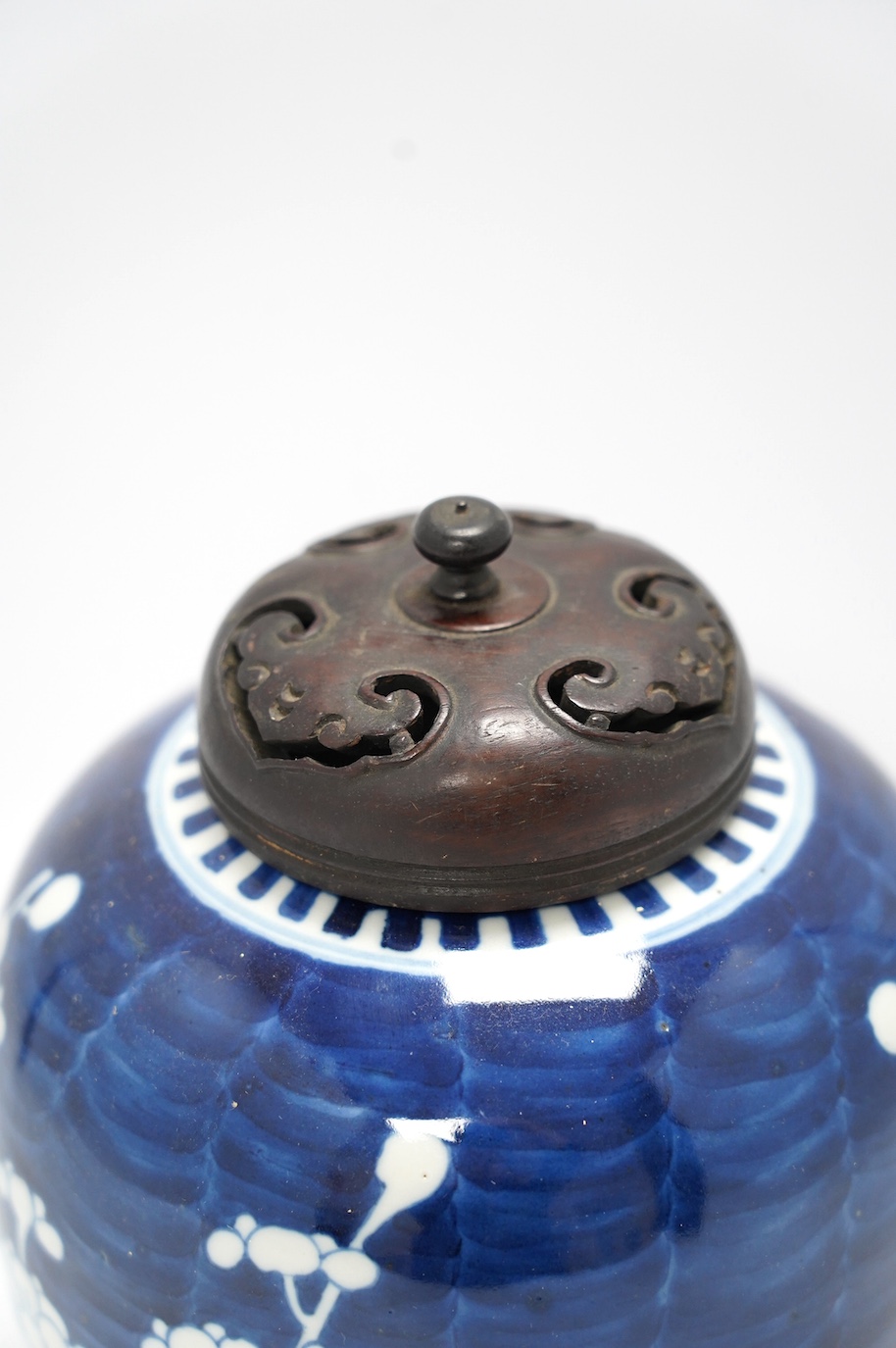 A Chinese blue and white prunus jar, with wood cover, early 20th century, 20.5cm high. Condition - good.
